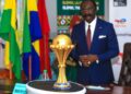 [FILES] Mr. Narcisse Mouelle Kombi, Minister of Sports and Physical Education looks on December 7, 2021 to the Africa Cup of Nations trophy presented in Yaounde by the General Manager of Total Energie in Cameroon Adrien Bechonnet. (Photo by Daniel Beloumou Olomo / AFP)