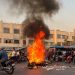A picture obtained by AFP outside Iran, shows people gathering next to a burning motorcycle in the capital Tehran on October 8, 2022. – Iran has been torn by the biggest wave of social unrest in almost three years, which has seen protesters, including university students and even young schoolgirls chant “Woman, Life, Freedom”. (Photo by – / AFP)