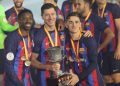(From L) Barcelona’s French forward Ousmane Dembele, Barcelona’s Polish forward Robert Lewandowski and Barcelona’s Spanish midfielder Gavi pose for pictures with the trophy after winning the Spanish Super Cup final football match between Real Madrid CF and FC Barcelona at the King Fahd International Stadium in Riyadh, Saudi Arabia, on January 15, 2023. (Photo by Giuseppe CACACE / AFP)