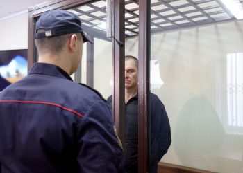 Andrzej Poczobut – a correspondent for the top Polish daily Gazeta Wyborcza and a representative of the Polish minority in Belarus, who was arrested in March 2021 and accused of “calling for actions aimed at harming national security” as well as inciting hatred, appears at the Grodno regional court on January 16, 2023. – The trial of Polish-Belarusian journalist opened in authoritarian Belarus on January 16, 2023, with the reporter facing up to 12 years in prison for criticism of President Alexander Lukashenko’s regime, in a case condemned by Warsaw. (Photo by Leonid SHCHEGLOV / BELTA / AFP) / Belarus OUT / BELARUS OUT