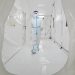 This photo taken on March 17, 2022, shows a staff member, wearing personal protective equipment (PPE), walking at the Fire Eye laboratory, a temporary Covid-19 coronavirus testing facility, before it opens in Yantai in China’s eastern Shandong province. (Photo by AFP) / China OUT