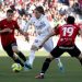 Real Madrid’s Croatian midfielder Luka Modric (C) vies with Real Mallorca’s South Korean forward Lee Kang-in (R) and Mallorca’s Spanish midfielder Inigo Ruiz de Galarreta during the Spanish League football match between RCD Mallorca and Real Madrid at the Visit Mallorca stadium in Palma de Mallorca on February 5, 2023. (Photo by JAIME REINA / AFP)