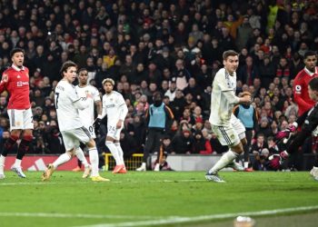 Manchester United’s English striker Jadon Sancho (2nd L) shoots and scores his team second goal during the English Premier League football match between Manchester United and Leeds United at Old Trafford in Manchester, north west England, on February 8, 2023. (Photo by Oli SCARFF / AFP)