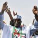 Candidate of the opposition Peoples Democratic Party (PDP) Atiku Abubakar raise hands during a campaign rally in Kano, northwest Nigeria, on February 9, 2023, ahead of February 25 presidential election. (Photo by PIUS UTOMI EKPEI / AFP)