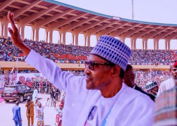 President Muhammadu Buhari acknowledge cheers from supporters.
