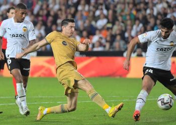 Barcelona’s Polish forward Robert Lewandowski (C) kicks the ball during the Spanish league football match between Valencia CF and FC Barcelona at the Mestalla stadium in Valencia. (Photo by JOSE JORDAN / AFP)