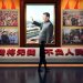 A man walks past a photo of Chinese President Xi Jinping at the Museum of the Communist Party of China in Beijing on March 3, 2023, ahead of the opening of the annual session of the National Peoples Congress on March 5. (Photo by GREG BAKER / AFP)