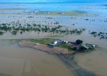 This handout photo taken on March 10, 2023 and received on March 11, 2023 from the Queensland Police Service shows an aerial view of the flooded northern Queensland town of Burketown. – Police urged all residents of the remote Australian town to evacuate on March 11, 2023, warning that record-high floodwaters were expected to rise further over the weekend. (Photo by Handout / QUEENSLAND POLICE SERVICE / AFP) /