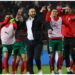 Morocco’s coach Walid Regragui (C) and his players greet the fans after the friendly football match between Morocco and Brazil at the Ibn Batouta Stadium in Tangier on March 26, 2023. (Photo by Fadel Senna / AFP)