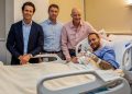 This handout picture provided by Aspetar Hospital in Doha on March 10, 2023 shows Paris Saint-Germain’s Brazilian forward Neymar da Silva Santos Junior (R) gesturing in bed after after undergoing surgery at the facility, accompanied by the hospital’s Chief Medical Officer Dr Pieter D’Hooghe (2nd-L), ankle surgeon Dr Pierre James Calder (2nd-R), and Brazilian surgeon and national team doctor Rodrigo Lasmar (L).