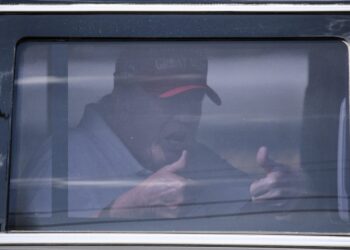 Former US President Donald Trump sits in the rear of his limousine as he departs Trump International Golf Club in West Palm Beach, Florida, on April 1, 2023. – Trump is expected to surrender to the authorities in New York on April 4, 2023 to face charges over a hush-money payment to porn star Stormy Daniels. (Photo by CHANDAN KHANNA / AFP)