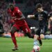 Arsenal’s Scottish defender Kieran Tierney (2R) shoots wide of the goal during the English Premier League football match between Liverpool and Arsenal at Anfield in Liverpool, north west England on April 9, 2023. (Photo by Paul ELLIS / AFP)