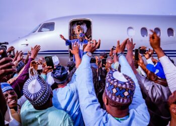 Nigeria president-elect Bola Tinubu waves supporters on arrival at the Nnamdi Azikwe International Airport, Abuja after a month break abroad.