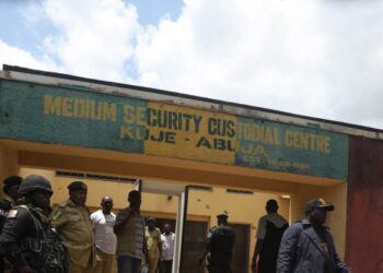 (FILES) In this file photo taken on July 06, 2022 Security officials stand outside Kuje Medium Security pison in Abuja, Nigeria after suspected Boko Haram gunmen attacked the Kuje Medium Prison. – After the July 5 incident that made global headlines and prompted President Muhammadu Buhari to say he was “disappointed” with his intelligence services, the police and military announced new measures to beef up security.Early August, the Inspector-General of Police Usman Alkali Baba “ordered (the) massive deployment of additional police operatives and operational assets within the Federal Capital Territory and its environs.”Despite steps taken to try and prevent further incursions, some government workers are concerned about gangs and jihadists getting closer to the capital. (Photo by Kola Sulaimon / AFP)