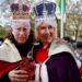 Royal fans wearing masks picturing Britain’s King Charles III (L) and Britain’s Camilla, Queen Consort (R) are pictured on The Mall, near to Buckingham Palace in central London, on May 5, 2023, ahead of the coronation weekend. – The country prepares for the coronation of Britain’s King Charles III and his wife Britain’s Camilla, Queen Consort on May 6, 2023. (Photo by Odd ANDERSEN / AFP)