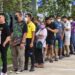 Voters wait in line to cast their ballot during advance voting at a polling station in a school in Narathiwat, southern Thailand, on May 7, 2023, a week ahead of the May 14 general election (Photo by Madaree TOHLALA / AFP)