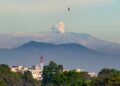 The Nevado del Ruiz volcano emits a cloud of ash as seen from Bogota, on May 18, 2023. – The 5,300-metre (17,400-foot) colossus in western Colombia is one of the many volcanoes along the Ring of Fire, a path around the Pacific basin characterized by active volcanoes and frequent earthquakes. The rumbling, notorious volcano has been showing increased seismic activity in the past weeks. (Photo by Guillermo MUNOZ / AFP)