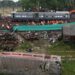 Railway workers help to restore services at the accident site of a three-train collision near Balasore, about 200 km (125 miles) from the state capital Bhubaneswar in the eastern state of Odisha, on June 4, 2023. – Railway teams worked non-stop on June 4 restoring tracks after India’s deadliest train crash in decades, a tragedy that has reignited safety concerns about one of the largest networks in the world. (Photo by Punit PARANJPE / AFP)