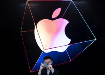(FILES) In this file photo taken on September 19, 2019 a man takes a picture with a new iPhone 11 inside the newly renovated Apple Store at Fifth Avenue in New York City. – Apple on August 5, 2021 said that iPhones and iPads will soon start detecting images containing child sexual abuse and reporting them as they are uploaded to the iCloud. The software tweak to Apple’s operating systems will monitor pictures, allowing Apple to report findings to the National Center for Missing and Exploited Children, according to a statement by the Silicon Valley-based tech giant. (Photo by Johannes EISELE / AFP)