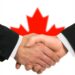 The Canadian flag and business handshake; Shutterstock ID 111141017; PO: aol; Job: production; Client: drone