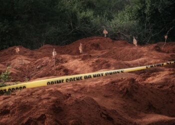 Digged holes are seen after exhuming bodies at the mass-grave site in Shakahola, outside the coastal town of Malindi, on April 25, 2023. (Photo by YASUYOSHI CHIBA/AFP)