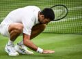 Serbia’s Novak Djokovic kisses the grass as he celebrates winning against Italy’s Jannik Sinner during their men’s singles semi-finals tennis match on the twelfth day of the 2023 Wimbledon Championships at The All England Lawn Tennis Club in Wimbledon, southwest London, on July 14, 2023. (Photo by SEBASTIEN BOZON / AFP)