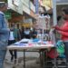 A street vendor selling necklaces puts up a stand in the central business district in Nairobi on July 20, 2023. – Shops and schools reopened on July 20, 2023 as Kenyans resumed normal life, despite an opposition call to join anti-government protests after earlier demonstrations prompted widespread closures and resulted in deadly clashes. (Photo by SIMON MAINA / AFP)