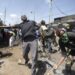 Protesters throw rocks in the direction of police on the third day of confrontations between authorities and supporters of the Kenyan opposition during anti-government protests in Kibera, Nairobi, on July 21, 2023. (Photo by Tony KARUMBA / AFP)