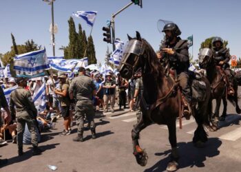 Members of Israel’s mounted security forces arrive at the site of a demonstration at the entrance of the parliament (Knesset) in Jerusalem on July 24, 2023, amid a months-long wave of protests against the government’s planned judicial overhaul. – Israeli lawmakers on July 24 prepared for a final vote on a major component of the hard-right government’s controversial judicial reforms even as US President Joe Biden called for postponing the “divisive” bill that has triggered mass protests. (Photo by HAZEM BADER / AFP)