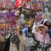 People lift placards demanding the release of political prisoners during an anti-government demonstration organised by the opposition National Salvation Front coalition in Tunis on July 25, 2023. (Photo by YASSINE MAHJOUB / AFP)