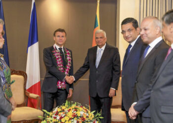 In this Handout photo released by Sri Lanka President's office shows, Sri Lankan President Ranil Wickermesinghe shakes hand with his French counterpart Emmanuel Macron during a meeting in Colombo, Sri Lanka, Friday, July 28, 2023. French President Emmanuel Macron held discussions with his Sri Lankan counterpart on an open and inclusive Indo-Pacific region and other areas such as politics, maritime activities and climate change in a first-ever visit by a French leader to the Indian Ocean island nation. (Sri Lanka President's office via AP)