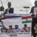 Protesters hold a Russian flag and a banner with images of (from L to R): General Abdourahamane Tiani, Nigers new strongman, Burkina Faso’s junta leader Captain Ibrahim Traore, leader of Mali’s junta, Assimi Goita, and Guinea’s junta leader, Colonel Mamady Doumbouya, during a demonstration on independence day in Niamey on August 3, 2023. – Security concerns built on August 3, 2023 ahead of planned protests in coup-hit Niger, with France demanding safety guarantees for foreign embassies as some Western nations reduced their diplomatic presence. (Photo by – / AFP)