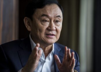 (FILES) This picture taken on March 25, 2019, shows exiled former Thai prime minister Thaksin Shinawatra being interviewed by Agence France-Presse (AFP) in Hong Kong. – Thailand’s political deadlock shows no signs of ending anytime soon, as months after national elections the kingdom’s lawmakers broker, bicker and break alliances with a new prime minister nowhere to be seen. (Photo by ISAAC LAWRENCE / AFP)