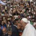 Pilgrims wave to Pope Francis as he departs the Sanctuary of Our Lady of Fatima, in Fatima, on August 5, 2023. – Around one million pilgrims from all over the world will attend the World Youth Day, the largest Catholic gathering in the world, created in 1986 by John Paul II. (Photo by Patricia DE MELO MOREIRA / AFP)