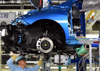 (FILES) An employee of Toyota Motors assembles FCV “Mirai” on its assembly line during the vehicle’s line off ceremony at the Motomachi factory in Toyota city, Aichi prefecture on February 24, 2015.  (Photo by Toshifumi KITAMURA / AFP)