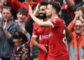 Liverpool’s Portuguese striker #20 Diogo Jota (R) celebrates with Liverpool’s Egyptian striker #11 Mohamed Salah after scoring their third goal during the English Premier League football match between Liverpool and West Ham United at Anfield in Liverpool, north west England on September 24, 2023. (Photo by Paul ELLIS / AFP)