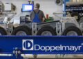 The company’s logo is seen at an assembly line for cable cars at the plant of Austrian Doppelmayr ropeway manufacturer in Wolfurt, western Austria, on September 12, 2023. – At the Austrian company Doppelmayr, the global leader of ropeway transport, “urban mobility” is a growing trend in the industry and meanwhile accounts for 20 percent of its sales. As cities worldwide eye cleaner, space-saving modes of transit, a cable car earmarked for the Paris region is being assembled at the Austrian plant. (Photo by ARND WIEGMANN / AFP)