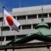 he national flag is seen on the roof of the Bank of Japan headquarters in Tokyo on September 22, 2022. – The Bank of Japan (BoJ) on September 22 will wind-up a two-day policy meeting and announce its decision later in the day. (Photo by Kazuhiro NOGI / AFP)