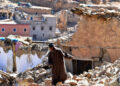 A man walks past debris from destroyed buildings in the earthquake-hit village of Ardouz, in Morocco’s Amizmiz region on September 14, 2023. – Rescue teams stepped up a massive effort to bring relief to devastated Moroccan mountain villages on September 14 as the chances faded fast for finding survivors from the powerful earthquake which killed 2,900 people and left hundreds of thousands homeless. (Photo by FETHI BELAID / AFP)