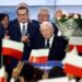 Polish Deputy Prime Minister and leader of the Law and Justice party (PiS) party, Jaroslaw Kaczynski (C) and Polish Prime Minister Mateusz Morawiecki (3L) of the Law and Justice party react with supporters at the party’s headquarters in Warsaw, Poland on October 15, 2023, after the presentation of the first exit poll results of the country’s parliamentary elections. (Photo by Wojtek Radwanski / AFP)