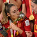 Spain’s defender #19 Olga Carmona (C) kisses the trophy as Spain’s players celebrate on the podium after winning the Australia and New Zealand 2023 Women’s World Cup final football match between Spain and England at Stadium Australia in Sydney on August 20, 2023. (Photo by Izhar KHAN / AFP)