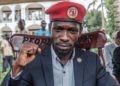 (FILES) Ugandan opposition leader Robert Kyagulanyi, also known as Bobi Wine, poses for a photograph after his press conference at his home in Magere, Uganda, on January 26, 2021. – Ugandan opposition leader Bobi Wine was arrested on October 5, 2023 on his return home from a trip abroad, a top party official said.“Our President (Bobi Wine) picked up by regime operatives as soon as he landed at the airport,” David Lewis Rubongoya, the general secretary of Wine’s National Unity Platform (NUP) said on X, formerly Twitter, with a photo appearing to show two men seizing him by the arms on the tarmac at Entebbe International Airport. (Photo by SUMY SADURNI / AFP)