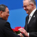 China's Premier Li Qiang (L) and Australia's Prime Minister Anthony Albanese shake hands during the opening ceremony of the 6th China International Import Expo (CIIE) in Shanghai on November 5, 2023. (Photo by Hector RETAMAL / AFP)