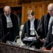 President Joan Donoghue (C), and other judges in the International Court of Justice (ICJ) take their seats prior to the hearing on the genocide case against Israel, brought by South Africa, in The Hague on January 11, 2024. – South Africa hopes that a landmark “genocide” case against Israel at the UN’s top court on Januray 11, will seek to compel Israel to halt its military operations in Gaza, where more than 23,000 Palestinians have been killed according to the Hamas-run Gaza health ministry. (Photo by Remko de Waal / ANP / AFP) / Netherlands OUT / NETHERLANDS OUT