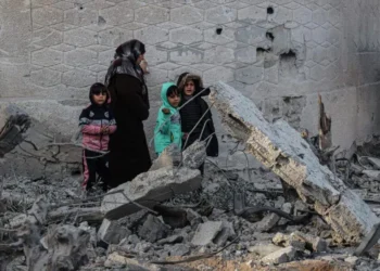 Palestinians walk amid the rubble of damaged buildings following Israeli bombardment in Rafah, on the southern Gaza Strip on February 12, 2024, amid ongoing battles between Israel and the militant roup Hamas. – Israel announced on February 12 the rescue of two hostages in the southern Gaza city of Rafah, where the Hamas-run health ministry said “around 100” Palestinians including children were killed in heavy overnight air strikes. (Photo by SAID KHATIB / AFP)